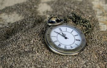 Pocketwatch on pile of sand