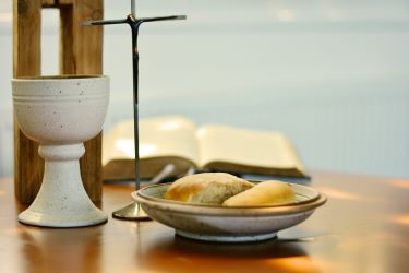 Communion elements of bread and wine with a cross