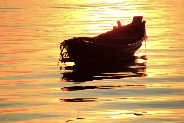Row boat on the water at sundown