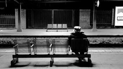 Person waiting on bench at train station